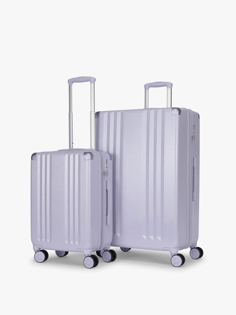 CALPAK Two Piece Amber Luggage Set with Carry On and Large size in light purple lavender with handles and spinner wheels on a white background