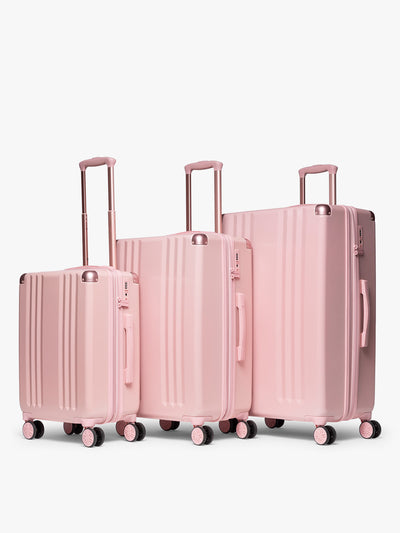 CALPAK pc Ambeur Luggage Set featuring the Ambeur Carry-On Luggage, Ambeur Medium Luggage and Ambeur Large Luggage in metallic pink Blossom with pink wheels;  LAM3000-BLOSSOM view 1