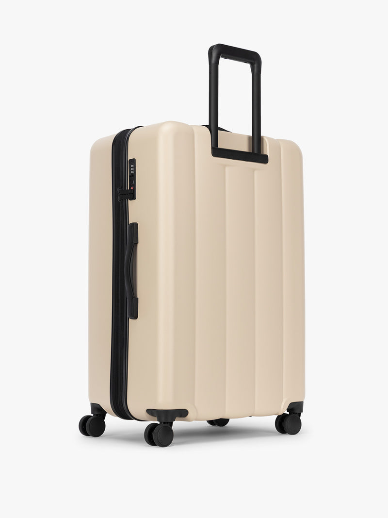 Backside of CALPAK Evry Large Luggage in beige exterior and interior polka dot in Polka Dot