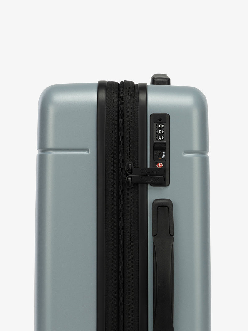 Side view of the CALPAK Hue Carry-On Luggage with the TSA-friendly lock in blue Bluebell; LHU1020-NP-BLUEBELL