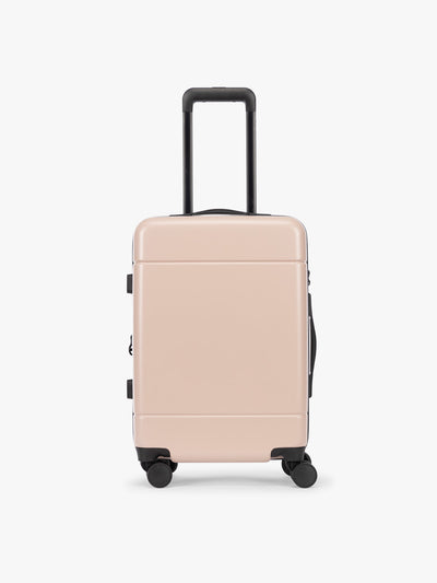 CALPAK Hue Carry On Luggage in light pink Rose Quartz with handle and wheels on a white background; LHU1020-NP-ROSE-QUARTZ view 1