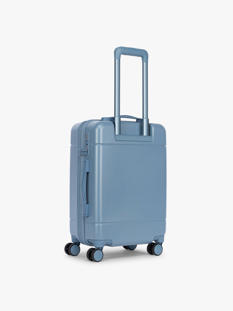 Back side of CALPAK Hue Carry On Luggage in light blue French Blue