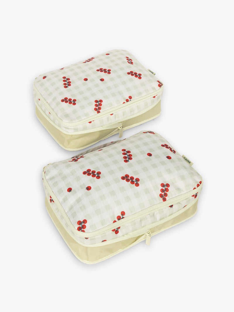CALPAK Medium Compression Packing Cubes in white and green gingham pattern with tomato print