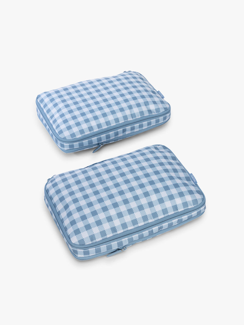 CALPAK Medium Compression Packing Cubes (Set of 2) compressed in white and blue gingham print in French Blue Gingham