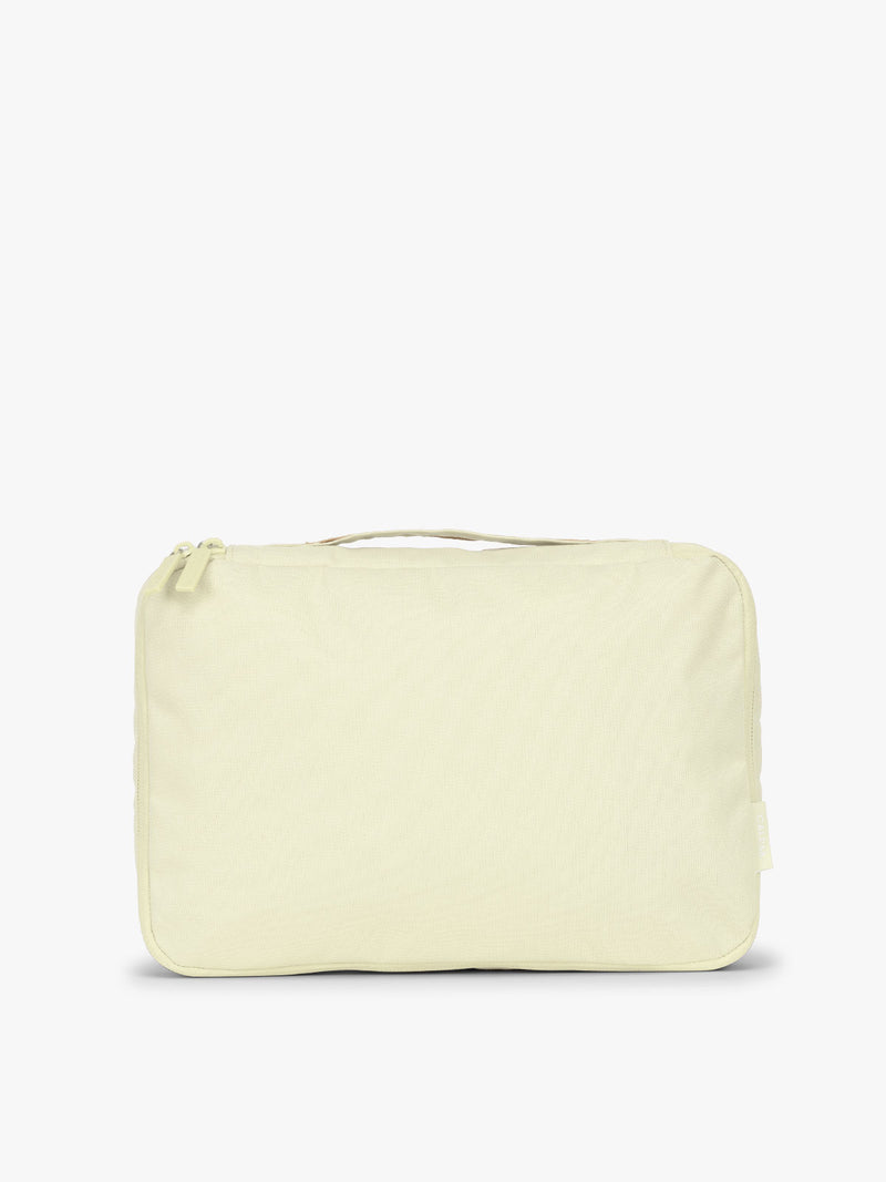 One of CALPAK Medium Compression Packing Cubes in light green Celadon