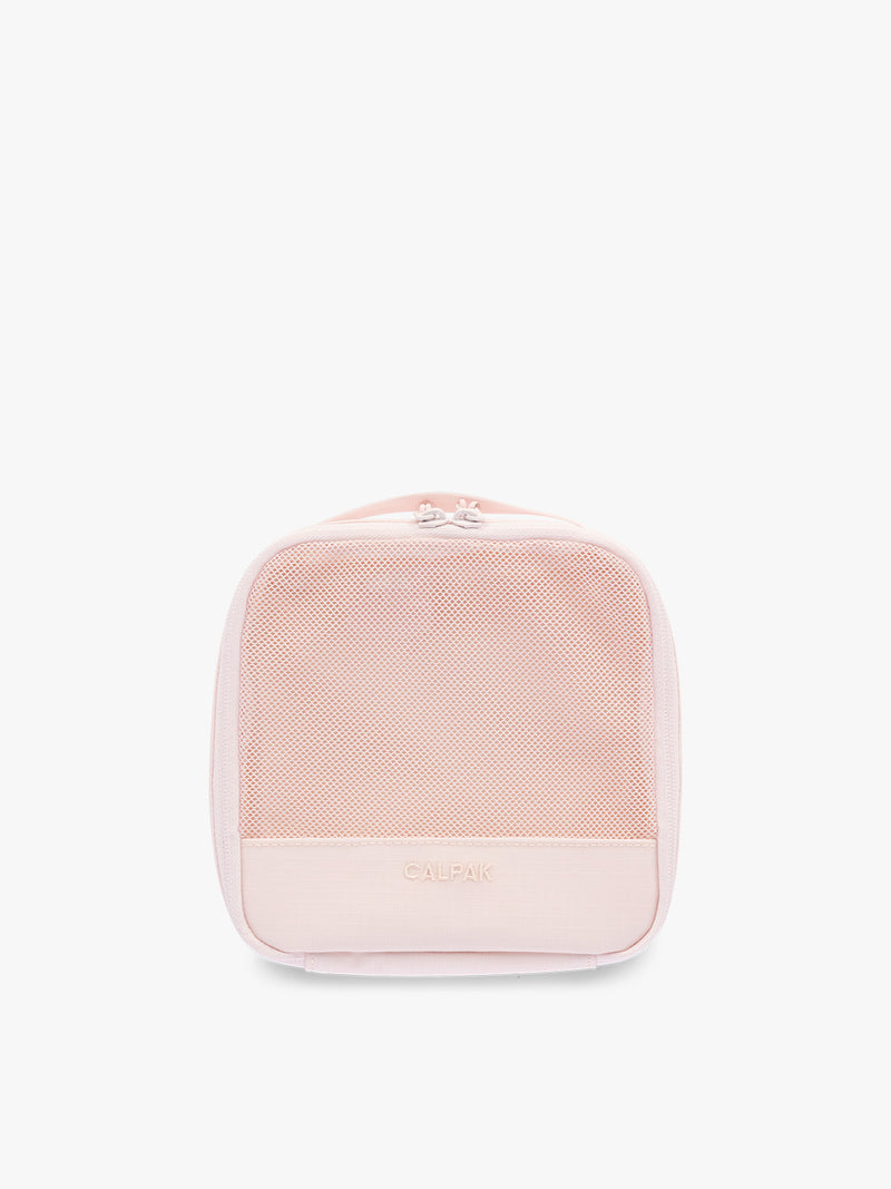 Small size packing cube of CALPAK Terra 5-Piece Packing Cube Set in pink Shell Pink with two small cubes, two medium cubes, and one large mesh cube with zippers and mesh