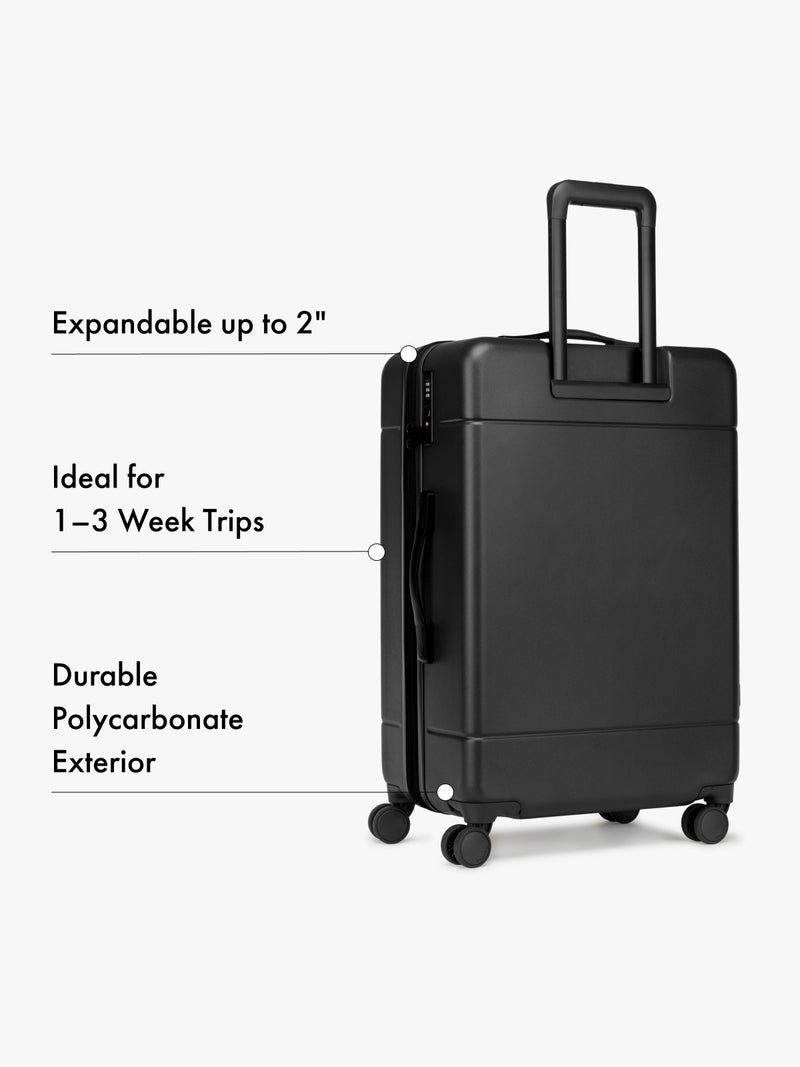 CALPAK large black suitcase with text highlighting features on a white background