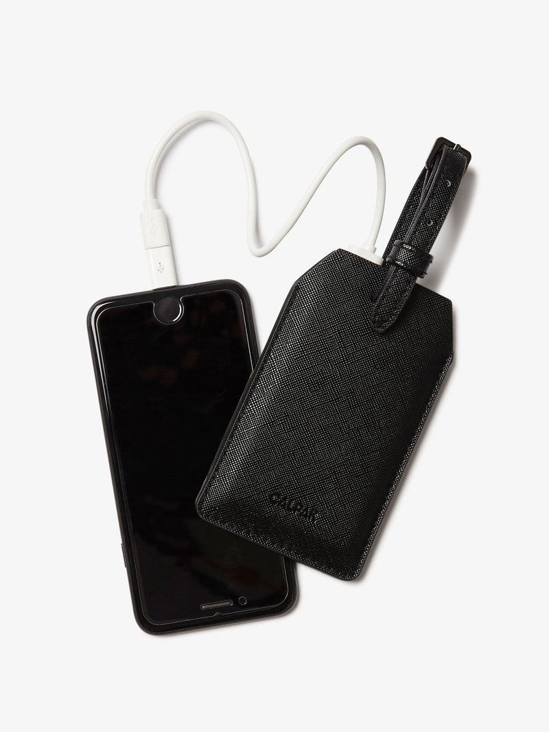 CALPAK Portable Luggage Tag + Charger with USB-C and Lightning adaptor compatibility in black