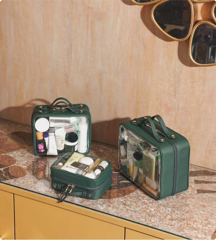 CALPAK green Clear Cosmetics Cases in small medium and large filled with cosmetics and skincare