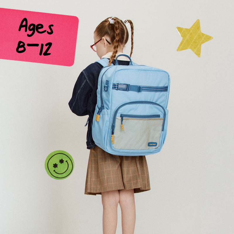 Child wearing a CALPAK Large backpack in blue with decorative elements and text indicating age range of 8-12 