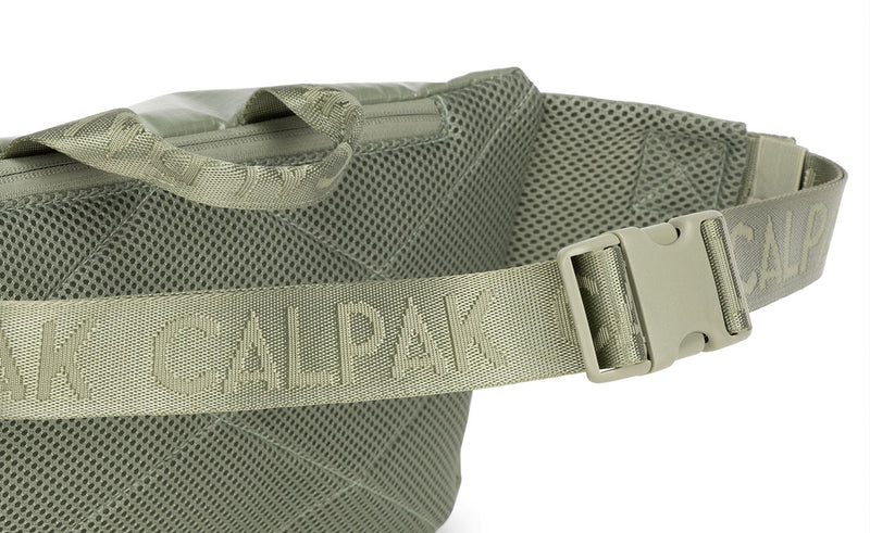 Close up image of the strap and buckle of CALPAK Terra Sling Bag in Juniper