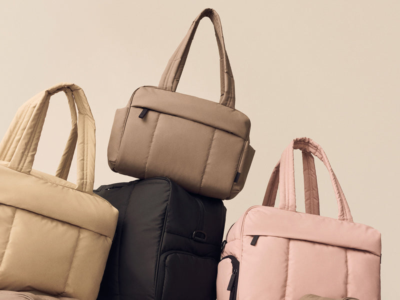 Stack of CALPAK Luka Mini Duffel in multiple colors