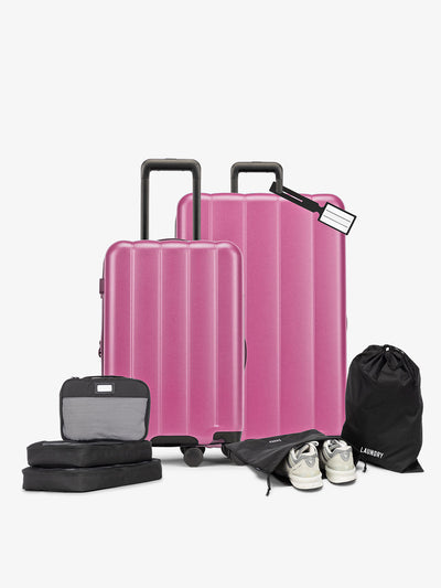CALPAK starter bundle with carry-on, large luggage, packing cubes, pouches, and luggage tag in raspberry; LCO8000-RASPBERRY view 1