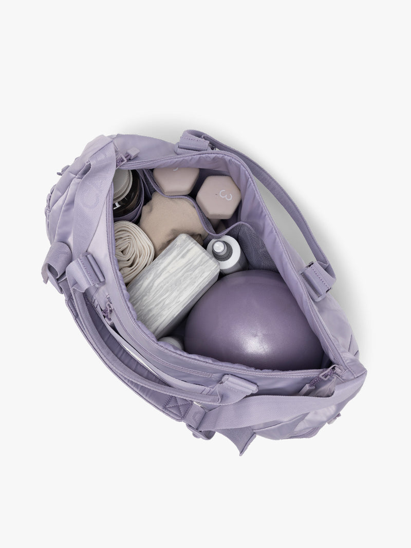 Gym items in the CALPAK Fit Gym Duffel Bag in purple Iris
