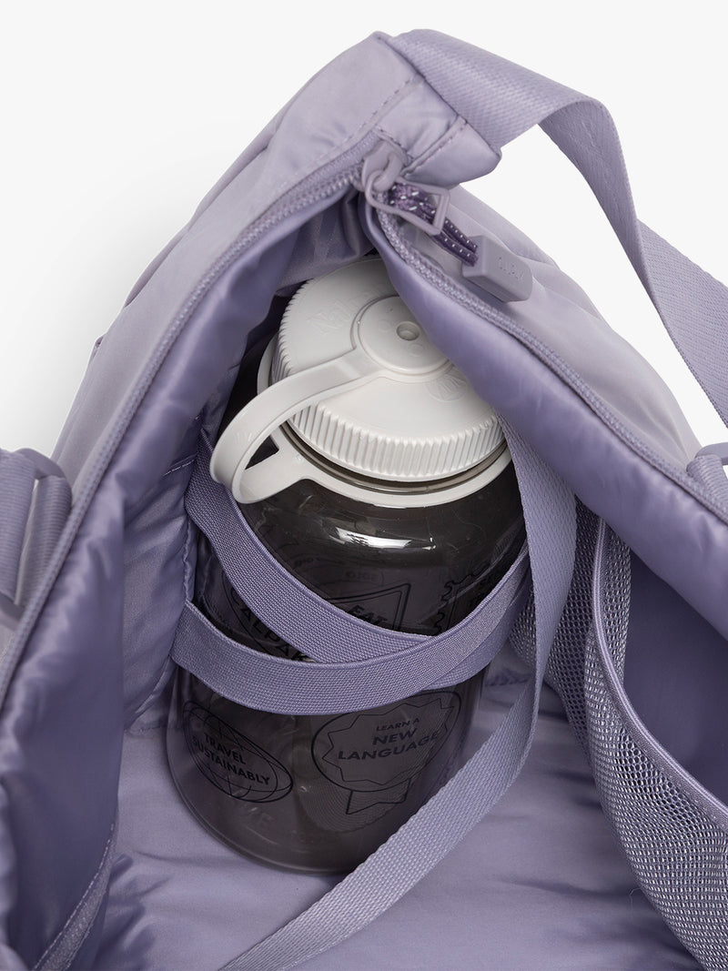 Water bottle in the CALPAK Fit Gym Duffel Bag in purple Iris