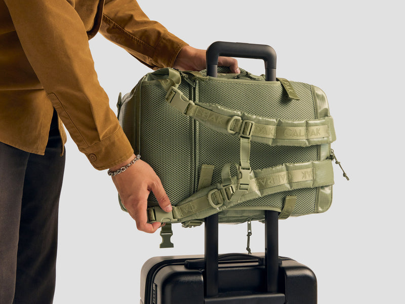 CALPAK 26L Terra Laptop Duffel Backpack being slipped on Luggage through the trolley sleeve