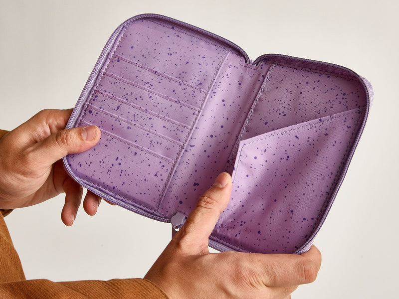 Model showing interior of Terra zippered passport wallet with card slots and passport pocket in purple amethyst
