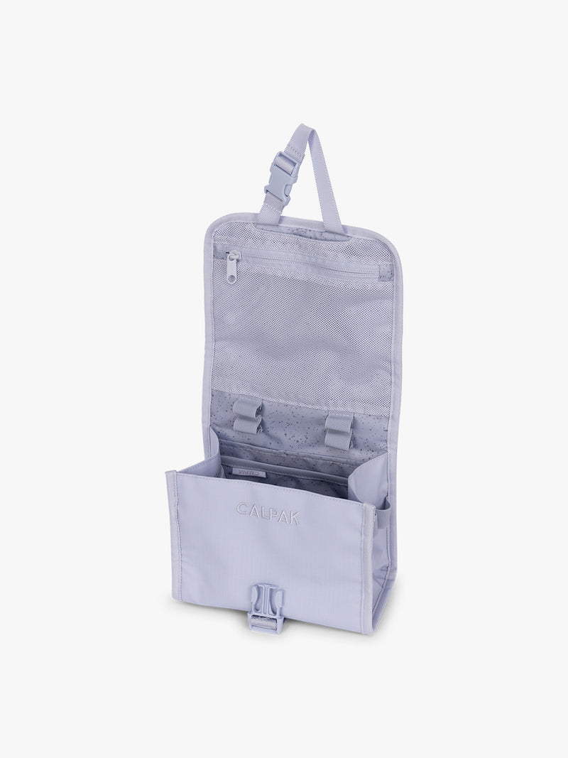 Opened CALPAK Terra Hanging Toiletry Bag in light purple Sea Glass with front buckle