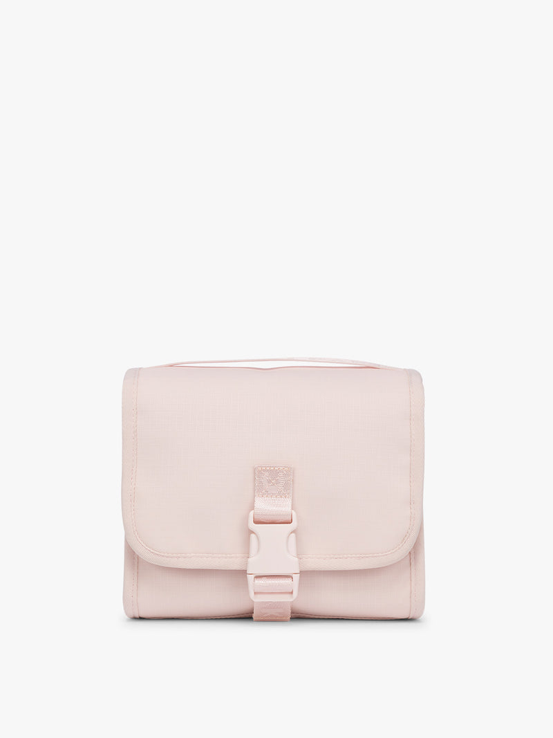 CALPAK Terra Hanging Toiletry Bag in light pink Shell Pink with front buckle