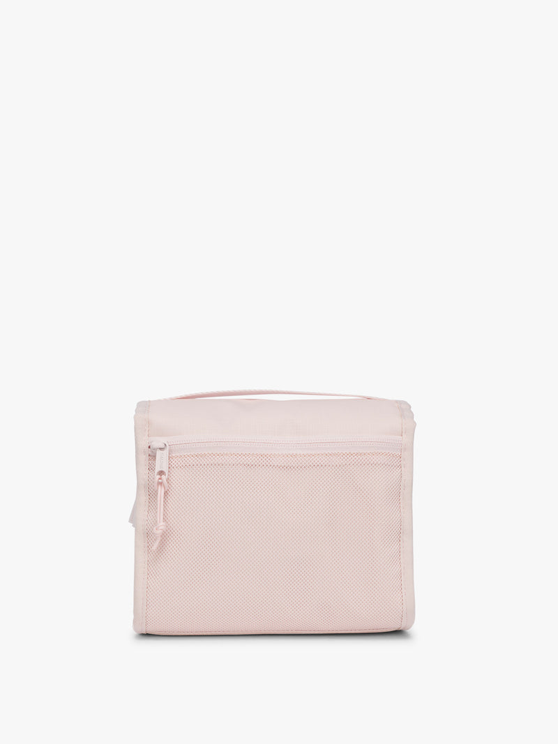 Backside of CALPAK Terra Hanging Toiletry Bag in light pink Shell Pink with front buckle