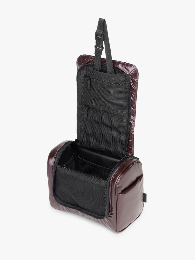 Opened view of CALPAK Luka Hanging Toiletry Bag in maroon Glazed Dark Cherry