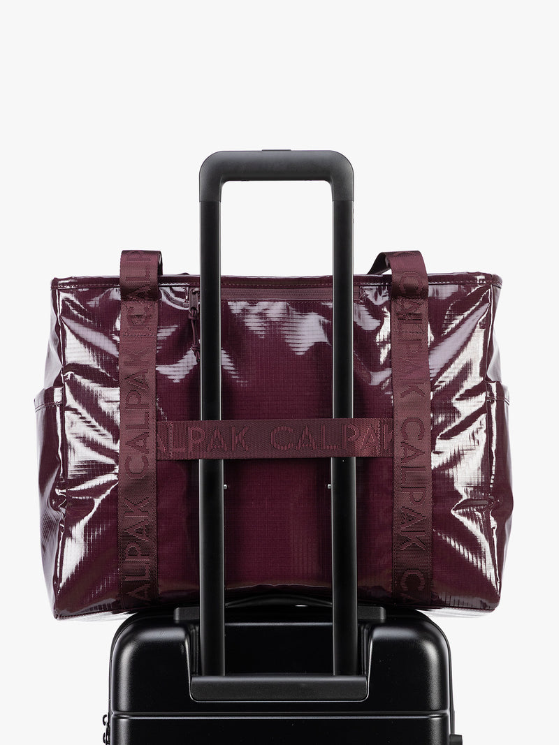 Back trolley sleeve of CALPAK Terra 35L Tote Bag with zippers in dark red Dark Cherry on a white background