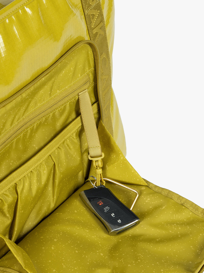 Key line of CALPAK Terra 35L Tote Bag with zippers in yellow green Wasabi on a white background