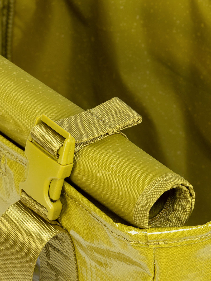 Rollable top of CALPAK Terra 35L Tote Bag with zippers in yellow green Wasabi on a white background