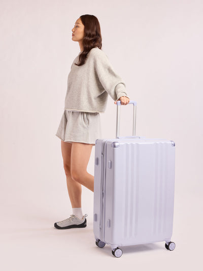 CALPAK Ambeur Large Luggage in light lavender purple with handles and spinner wheels on a white background; LAM1028-SEA-GLASS view 2