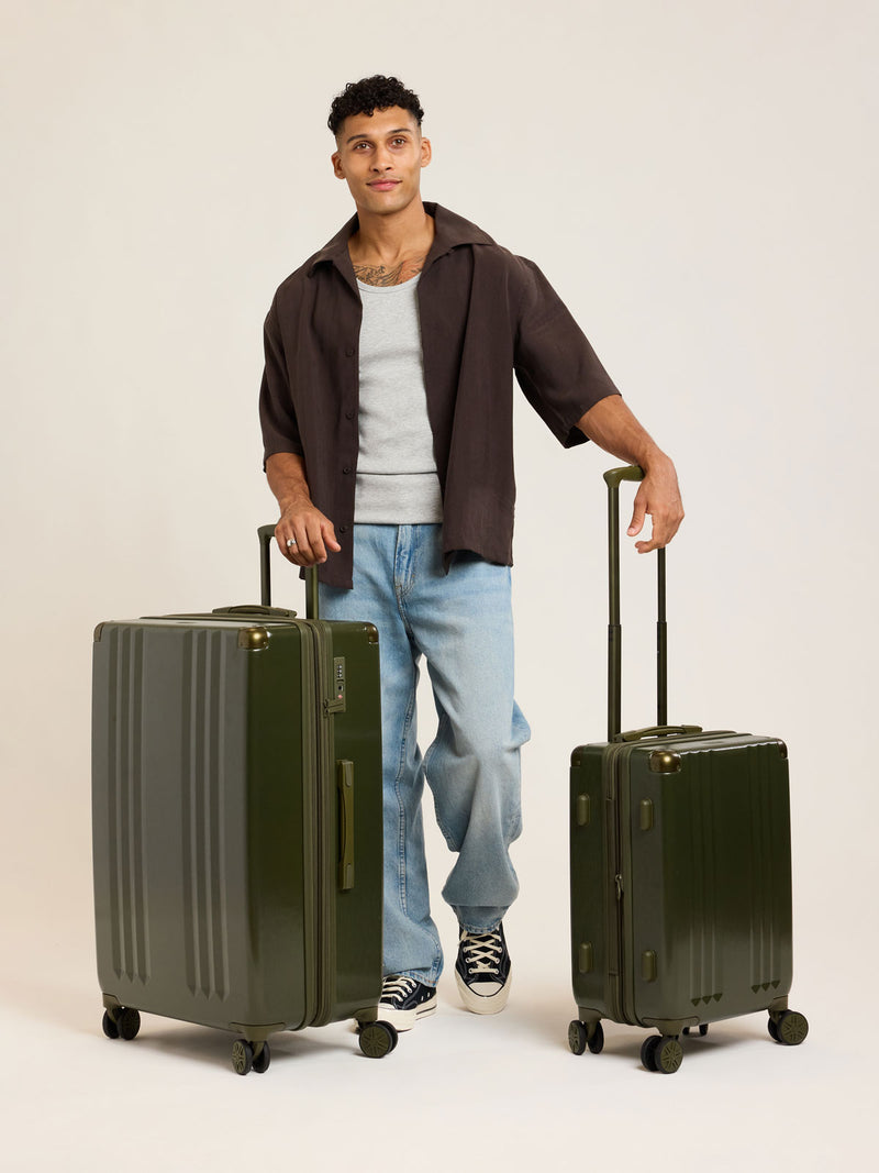 Model with CALPAK dark green Pine 2pc Luggage Set