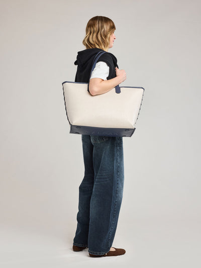CALPAK Colette 15 Canvas Laptop Tote in beige canvas material  with blue finishing in Natural Navy; CLCT2601-NATURAL-NAVY view 2