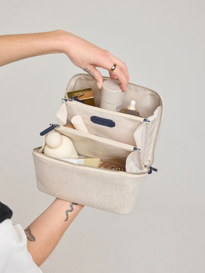 CALPAK Colette Lay-Flat Canvas Toiletry Bag in beige canvas material and blue finishing; CLTB2601-NATURAL-NAVY view 2