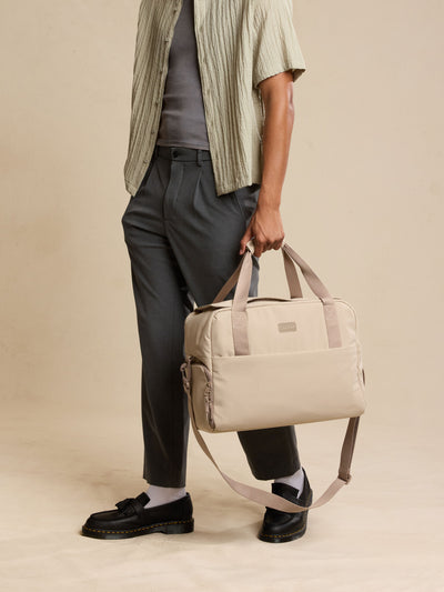 CALPAK Laptop Duffel in beige Greige front view with white background; DCN2401-GREIGE view 2