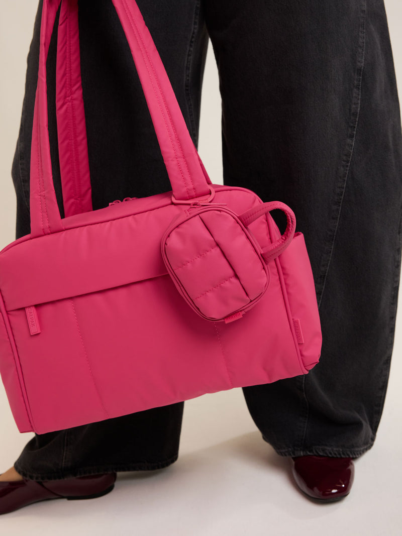 CALPAK Luka Duffel Zip Bag Charm in bright pink Dragonfruit on the CALPAK Luka Mini Duffel in bright pink Dragonfruit