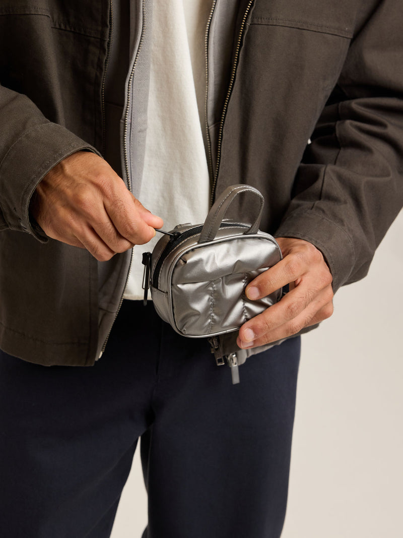 Model with CALPAK Luka Duffel Zip Bag Charm in dark silver Gunmetal