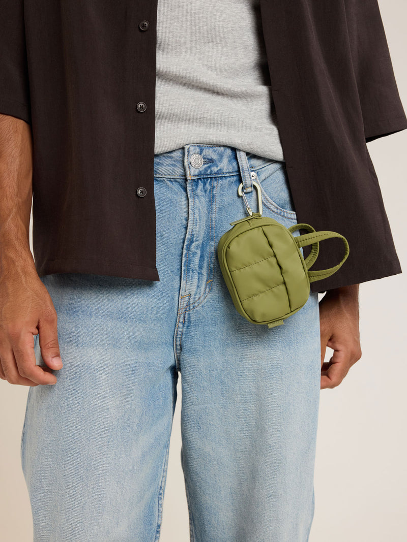 Model with attached CALPAK Luka Duffel Zip Bag Charm in green Pistachio