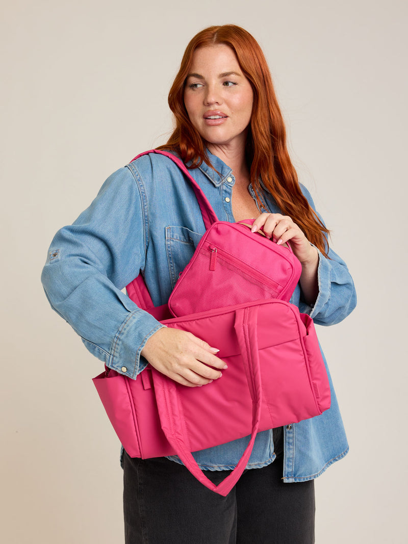 Model with CALPAK Everything Cube in bright pink Dragonfruit