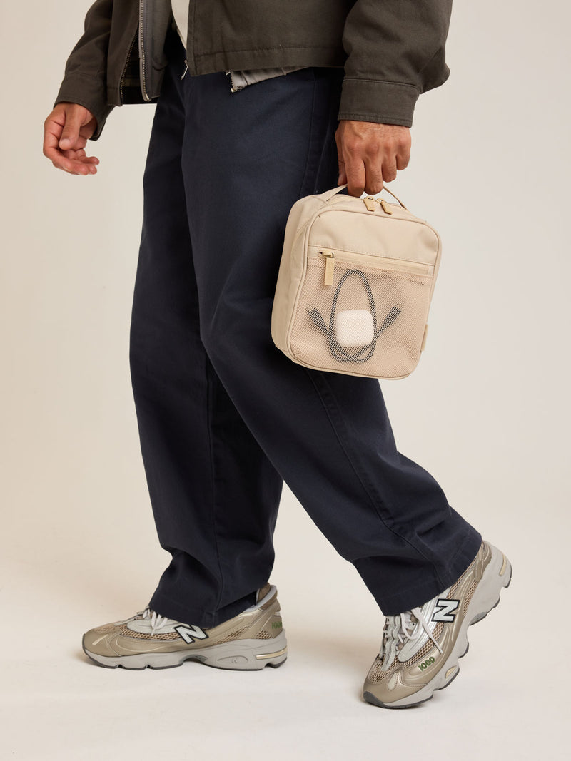 Model holding CALPAK Everything Cube in beige Oatmeal