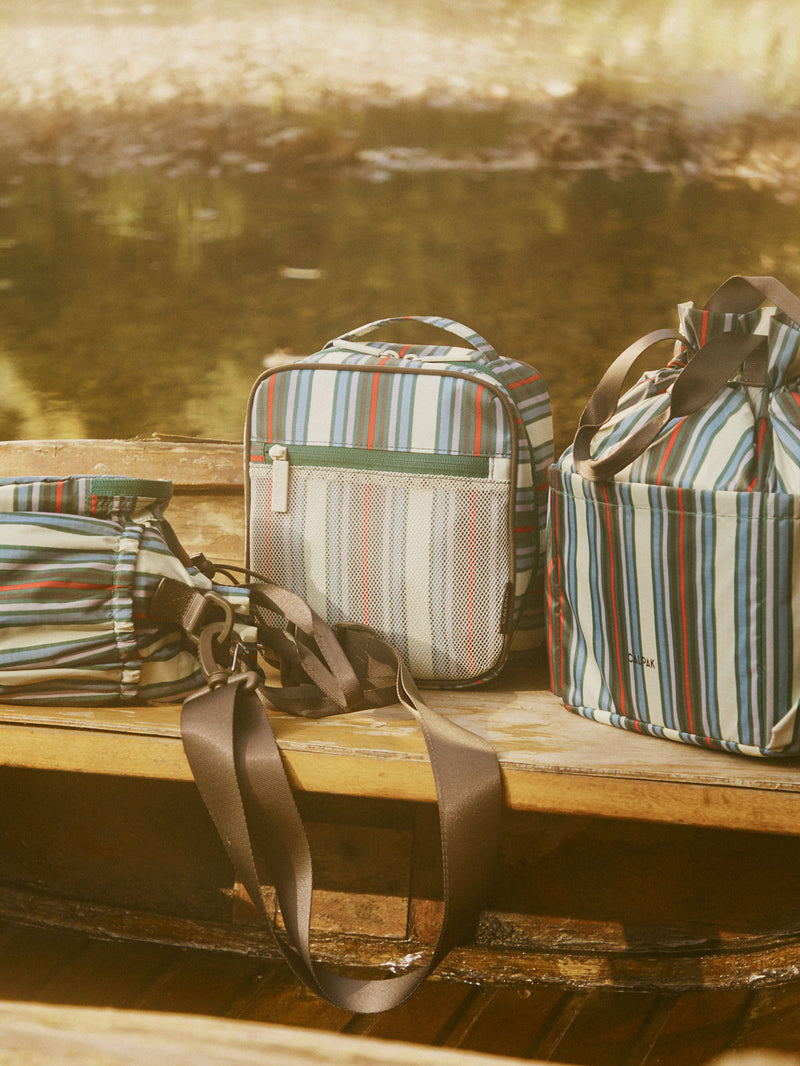 CALPAK Everything Cube in multicolor stripe on a bench
