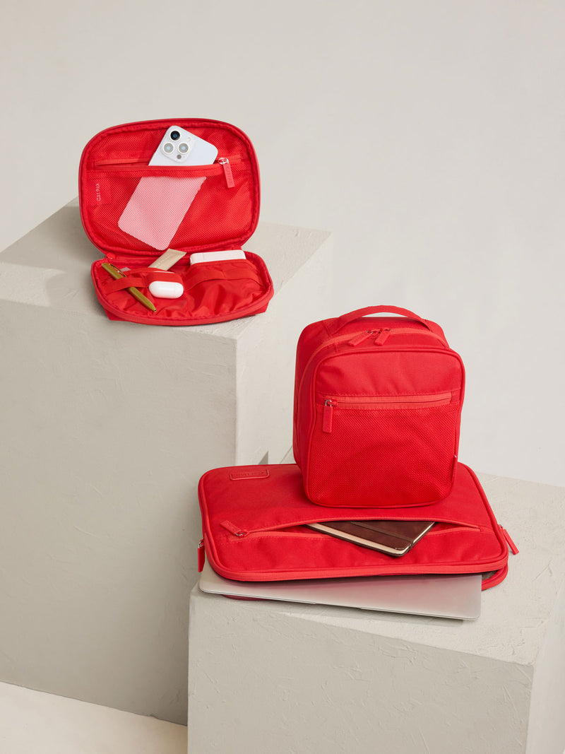 CALPAK Everything Cube in red Tomato on a stool
