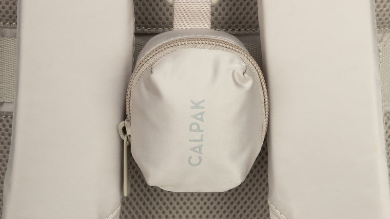 CALPAK Fit Bag Charm in grey beige Greige clipped on bag 