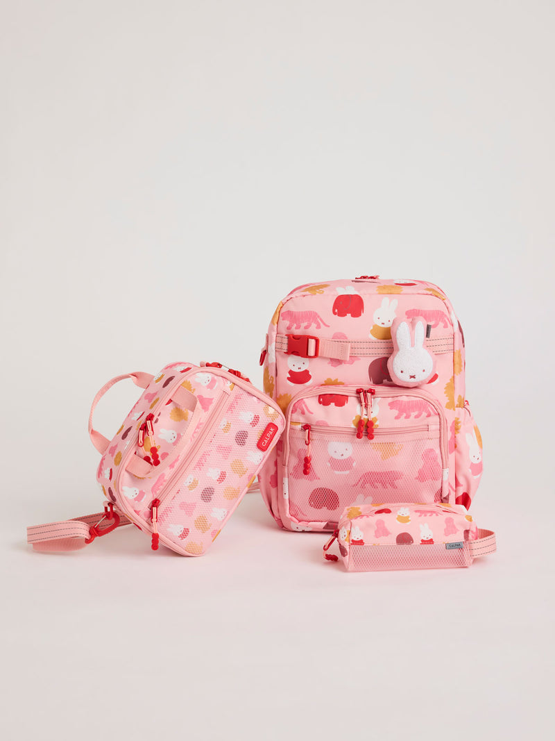 Colorful CALPAK + Miffy Kids Essentials Set with children's Large backpack, lunch bag , pencil case set on a white background with pink accents and Miffy with other animals