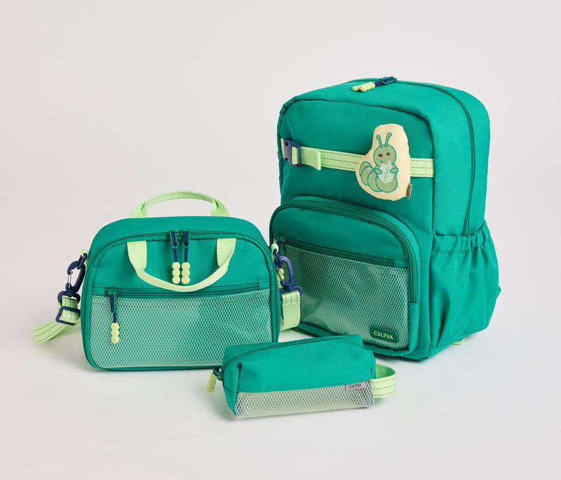 Green backpack with matching lunch bag and pouch on a light gray background