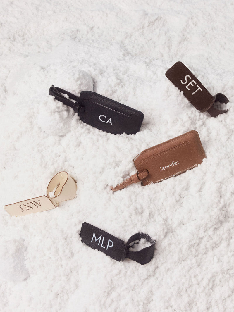 CALPAK Personalized Luggage Tags in beige Buttercream, brown Espresso and Black in the snow