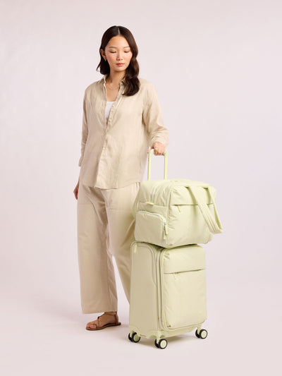 CALPAK Luka Soft-Sided Carry On Luggage in light green Celadon on a white background with handle and spinner wheels; LSM1020-CELADON view 2