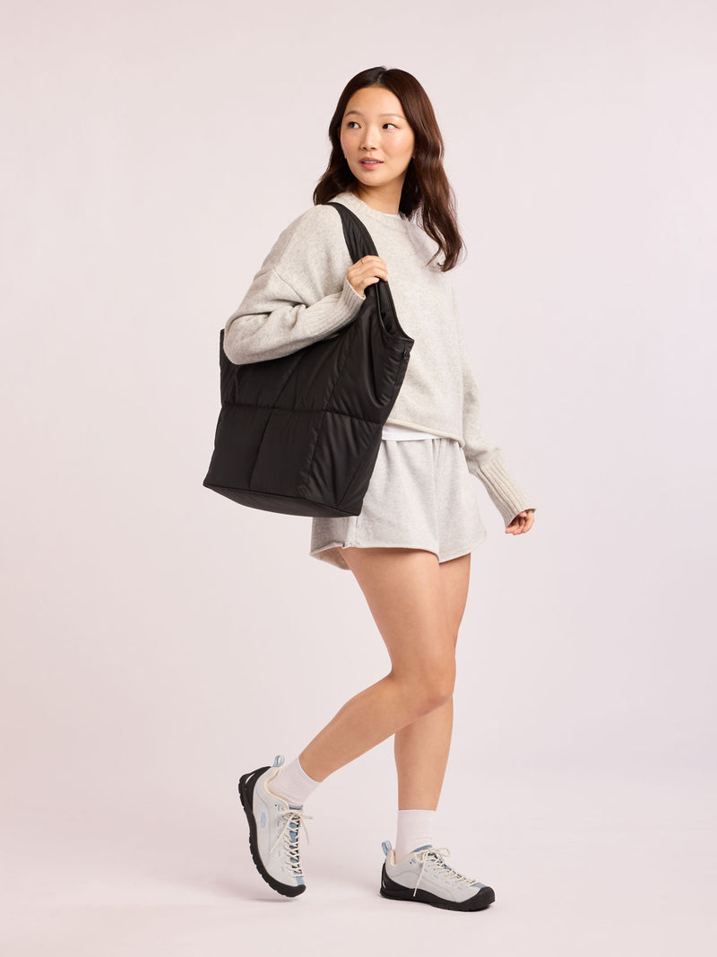 Model wearing CALPAK Luka Everything Tote in black