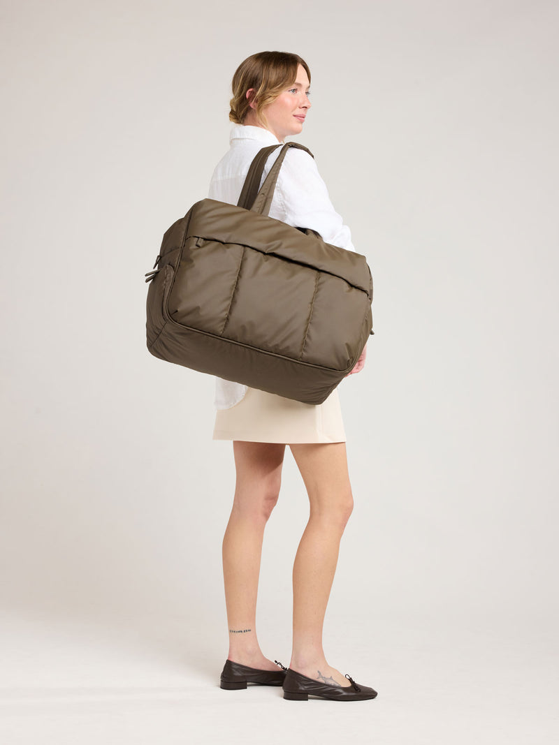 Woman with CALPAK Luka Large Duffel in brown Mushroom