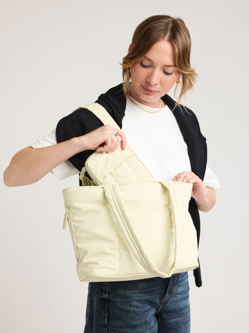 Modeling  wearing CALPAK Luka Mini Tote in light green Celadon