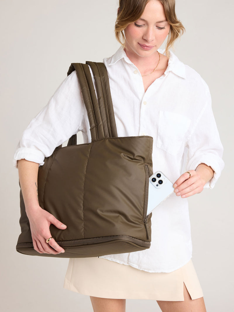 Person with CALPAK Luka Expandable Tote in brown Mushroom