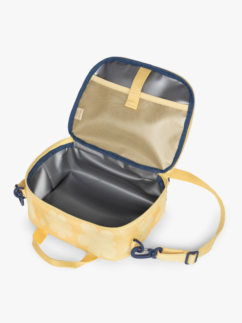 CALPAK Kids Lunch Bag in yellow with tan flower print in Yellow Bloom opened view with water-proof lining, insulated, and mesh pocket
